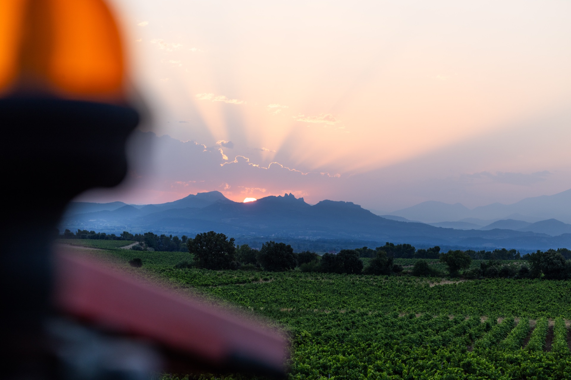 Sun coming up behind the ridge, the tractor's beacon blurred in the foreground