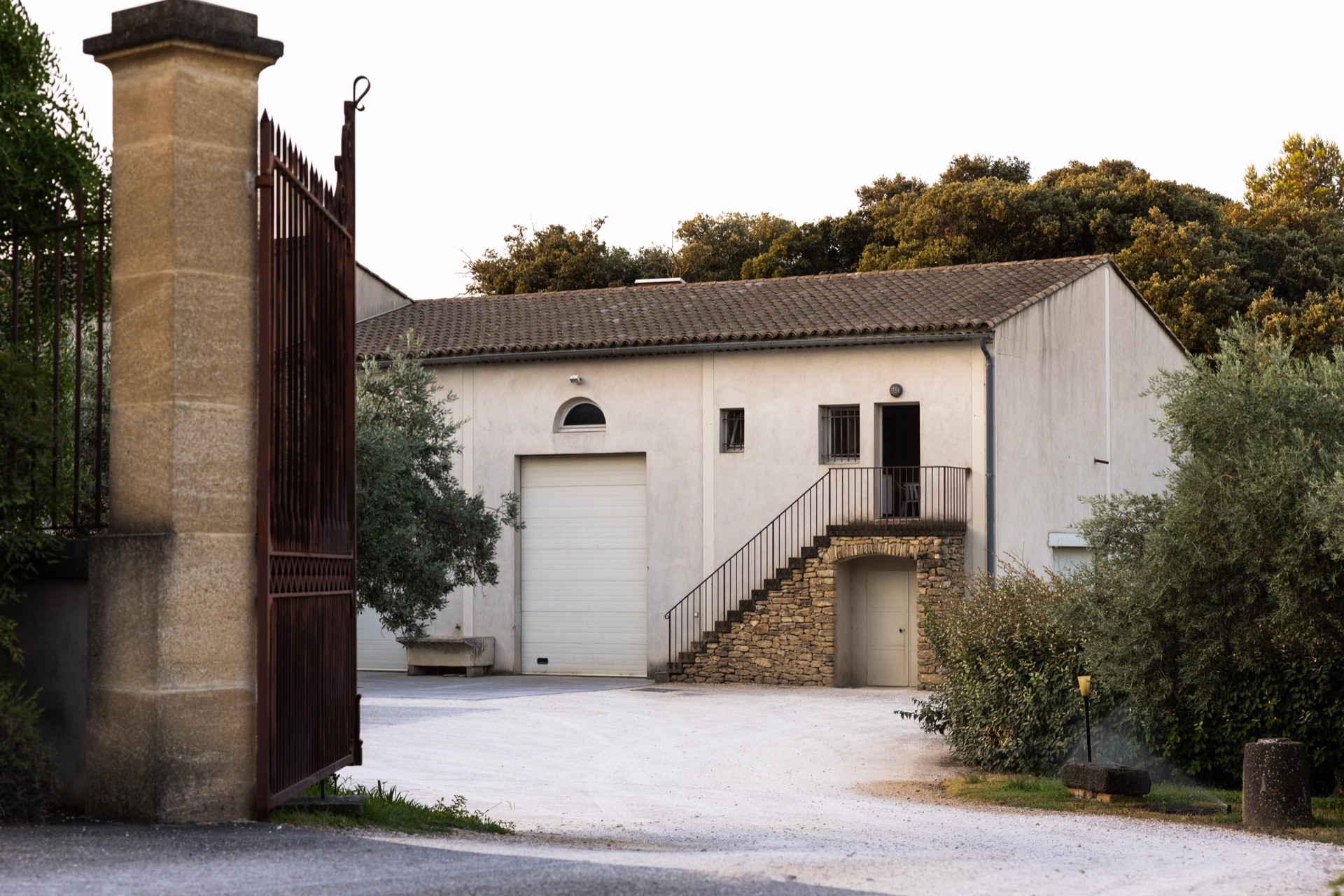 The open gate and cellar building at the estate in morning light
