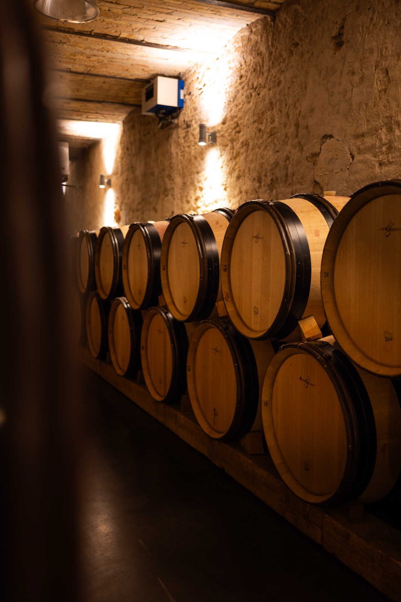 Barrels stacked two high along the stone wall of the cave