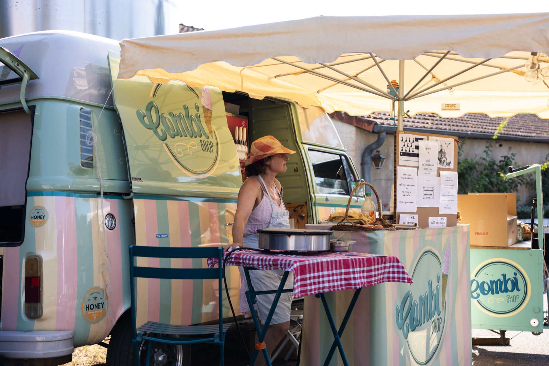Pastel Combi van kitchen serving guests under a parasol