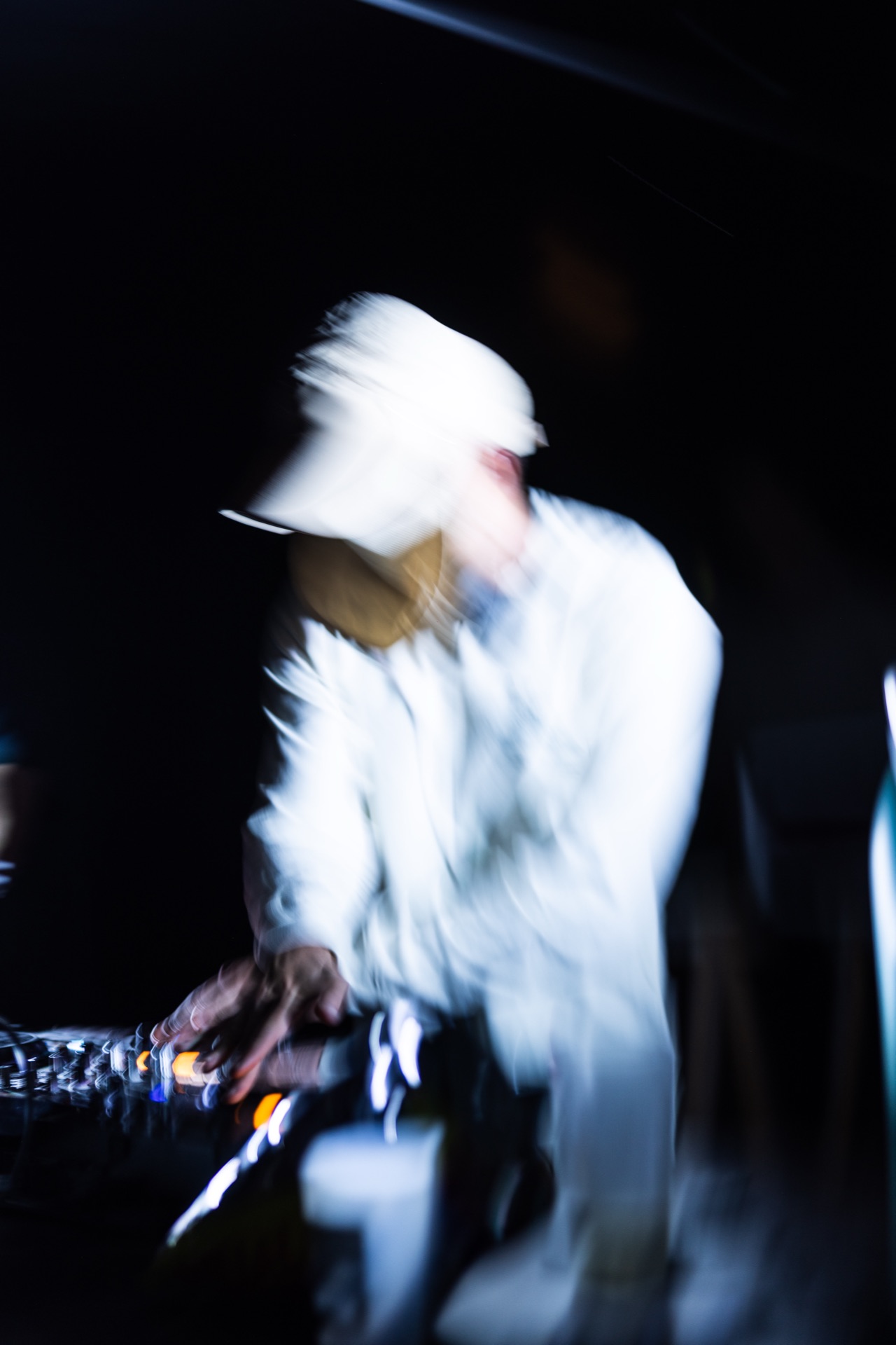 Slow-shutter frame of the DJ at the decks