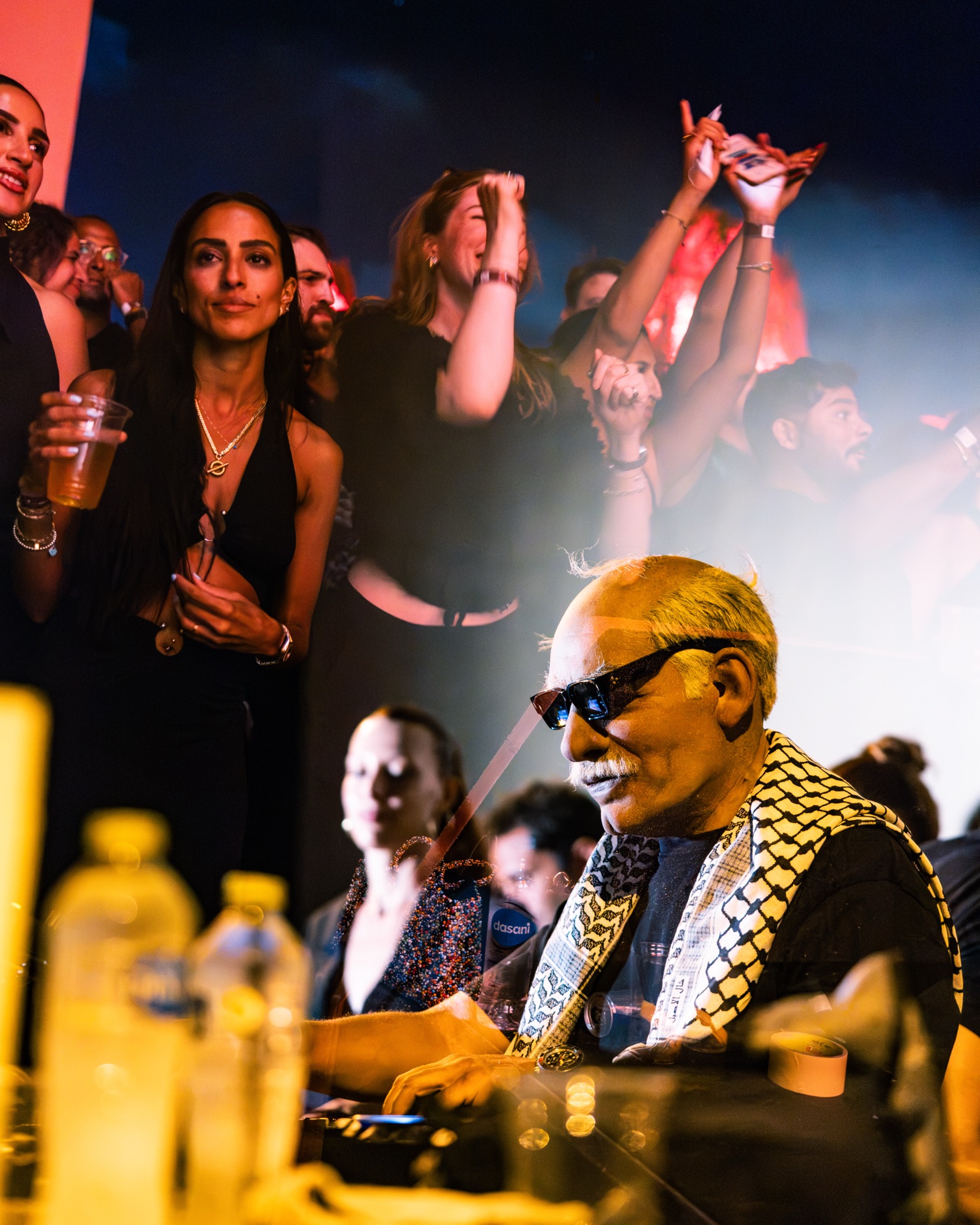 The crowd dancing directly behind the decks, drinks up