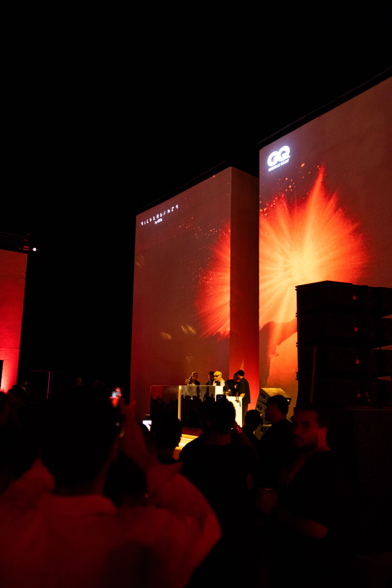 Wide of the stage, the crowd silhouetted against the Silversands and GQ screens