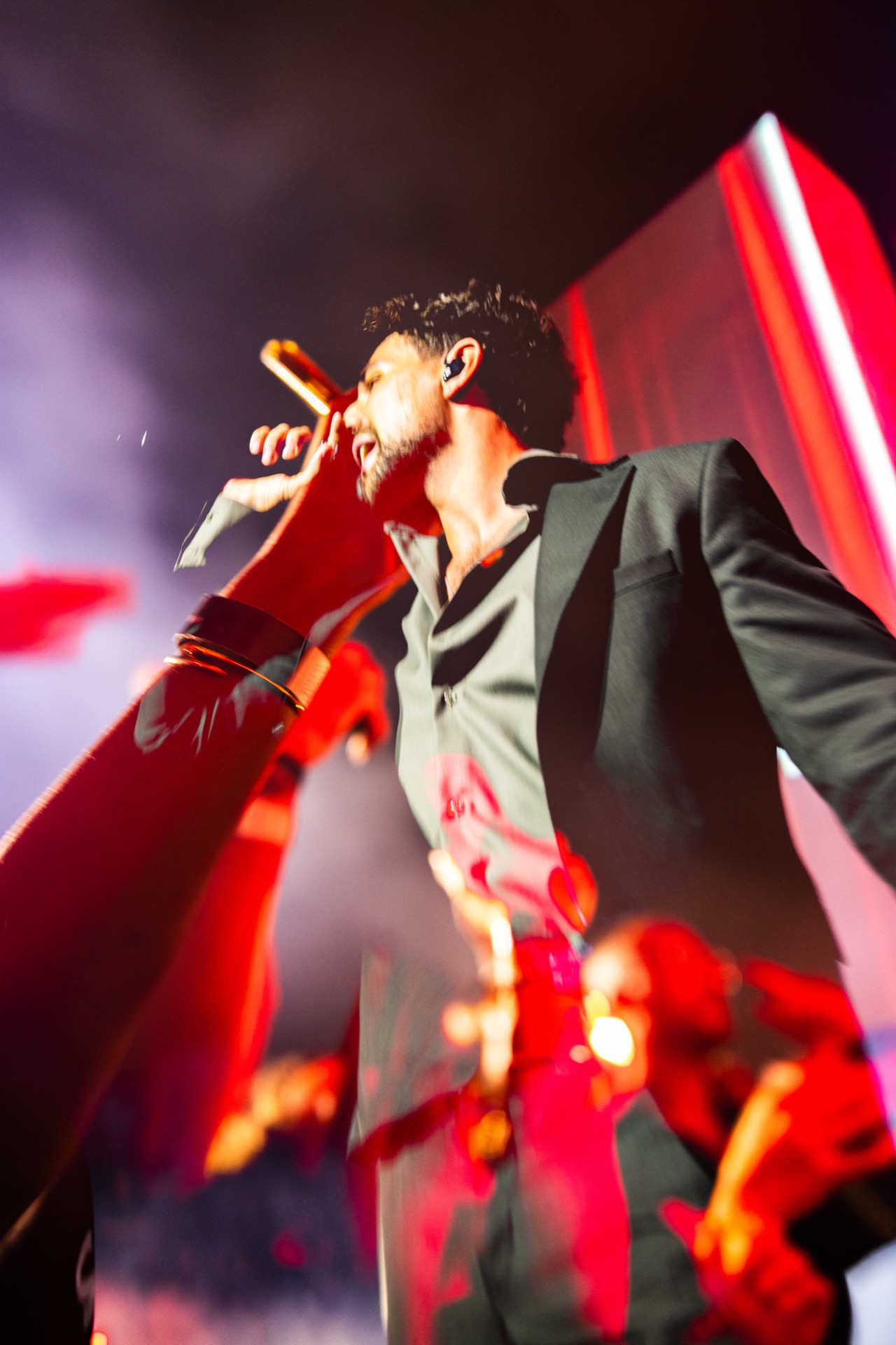 Low angle in red, a fan's arm reaching into the frame