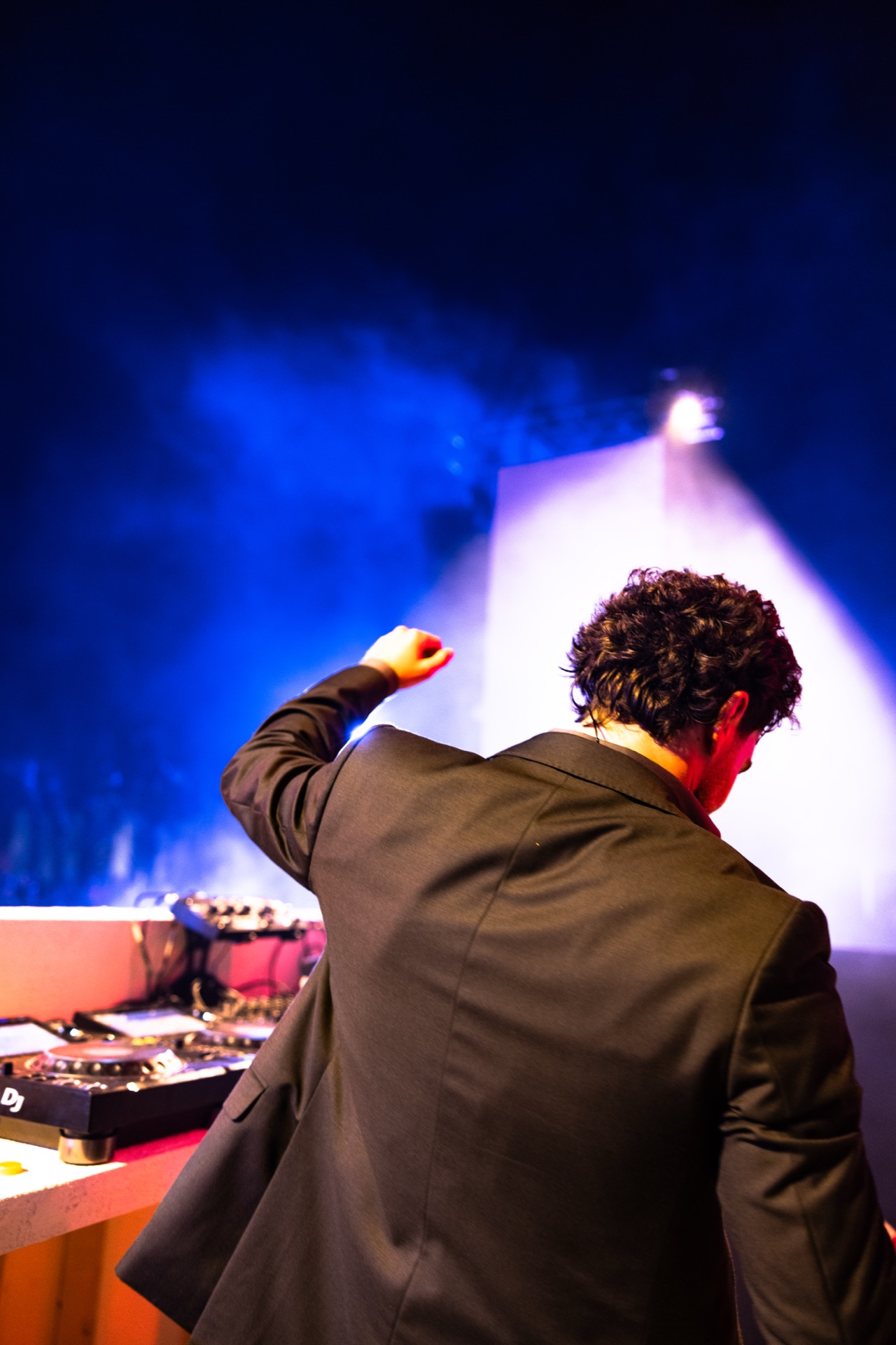 Turned away from camera at the decks as the set closes out in blue